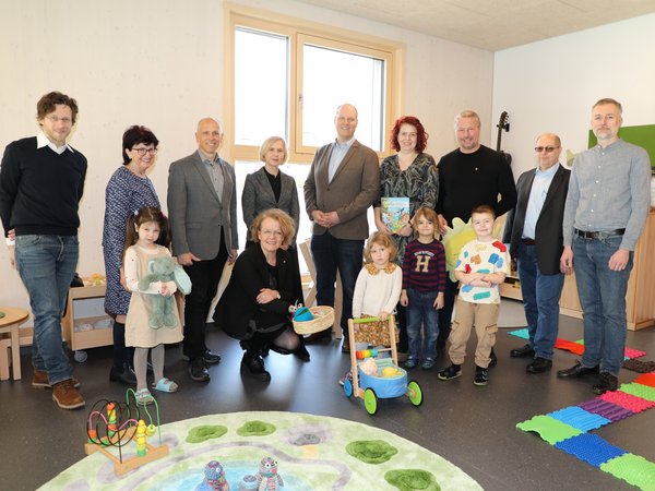 Zahlreiche Vertreter von Stadt und Politik mit Kindergartenkindern im neuen Zubau